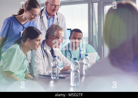 Surgeon, doctors and nurses meeting, using laptop in hospital meeting Stock Photo