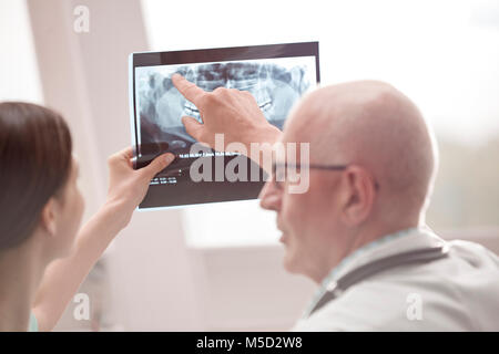 Doctor and nurse reviewing x-ray in hospital Stock Photo