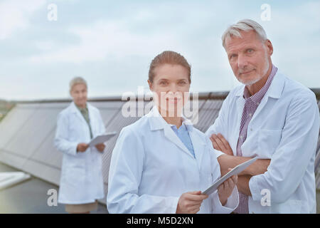 Portrait confident doctors with digital tablets Stock Photo