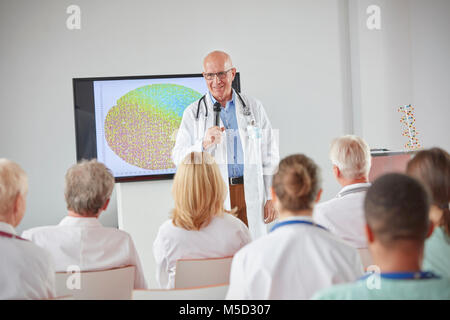 Male surgeon with microphone leading conference Stock Photo