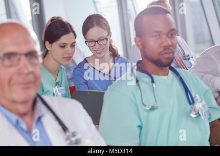 Female nurses talking in conference audience Stock Photo