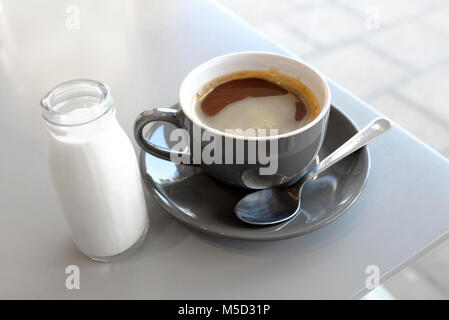 americano coffee with milk in small glass bottle, norfolk, england Stock Photo