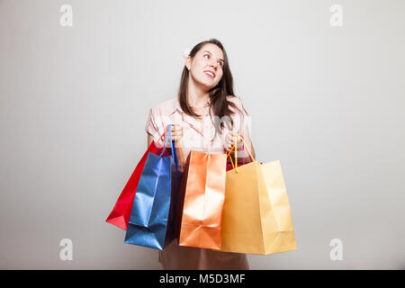 Young mother smiles carrying products to family Stock Photo