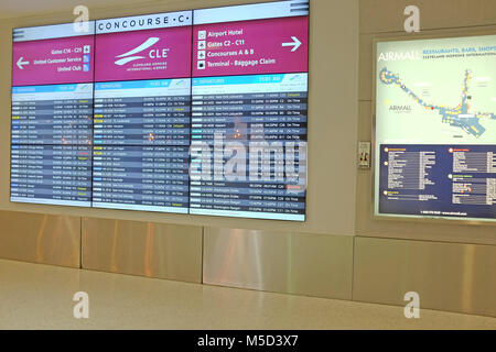 The February 10, 2018 departure board at Cleveland Hopkins International Airport shows the upcoming flights. Stock Photo