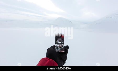 Navigation with compass in winter, Kungsleden or Königsweg, Province of Lapland, Sweden, Scandinavia Stock Photo