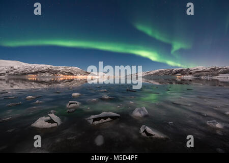 Northern lights over fjord with ice floes, island of Senja, Troms, Norway Stock Photo