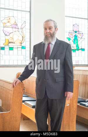 a rabbi stands in a synagogue for a portrait Stock Photo