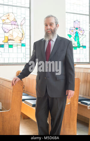 a rabbi stands in a synagogue for a portrait Stock Photo