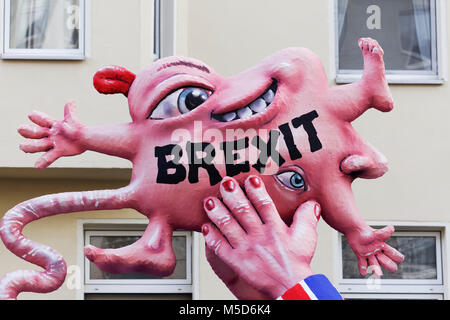British Prime Minister Theresa May holds a deformed child, Brexit-Baby, political caricature to Brexit, motto caravan during Stock Photo