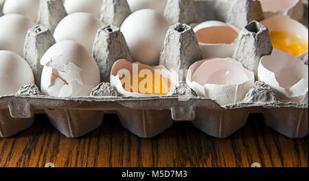 cracked white eggs in carton Stock Photo
