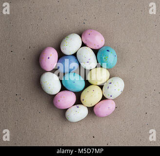 Easter candy eggs over brown background Stock Photo