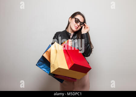 Smiling young girl holds gift bags Stock Photo