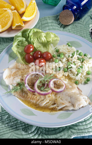 Grilled Alaskan Pollock fish fillets with lemon butter and green rice ...