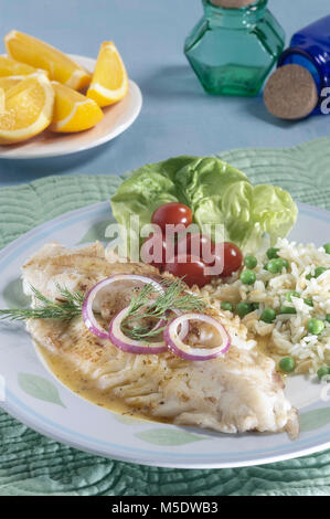 Grilled Alaskan Pollock fish fillets with lemon butter and green rice ...