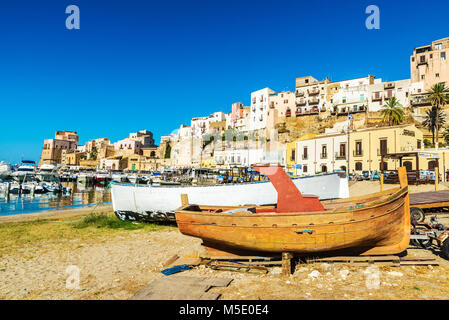 Castellammare del Golfo, Italy - August 7, 2017: Old wooden fishing boat moored on the beach in summer in Castellammare del Golfo in Sicily, Italy Stock Photo