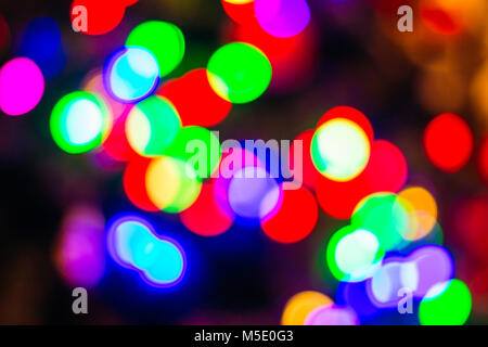 Multi-colored Christmas tree New Year's lights in blur. Background Stock Photo