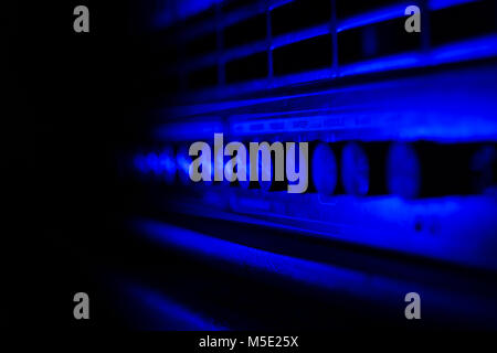 Close up of guitar amplifier control panel. Blue light, ideal for background, Space for copy. Stock Photo