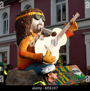 Rhenish carnival,Rose Monday,Shrove Monday procession 2018 in Duelken,people,fools,costuming,puppet on a carnival float,hippie portrayal with guitar and LSD drug cigarette,hippie movement,D-Viersen,D-Viersen-Duelken,Lower Rhine,Rhineland,North Rhine-Westphalia,NRW