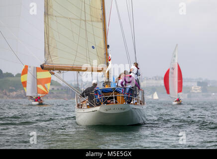 The yacht Sibyl Of Cumae follows other classic boats towards Drake's Island in Plymouth Sound. Stock Photo