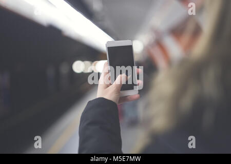 Close up of hand using a blank screen smartphone. Shallow depth of field. Stock Photo