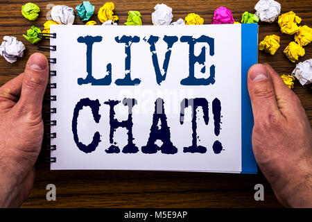 Writing text showing Live Chat . Business concept for Communication Livechat written notepad notebook book on the wooden wood background with man busi Stock Photo