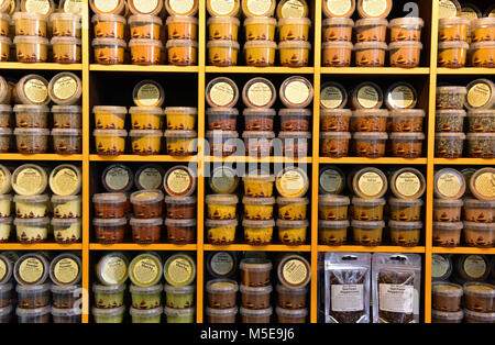 a spice store shelves full of a variety and choice of exotic herbs and spices at borough market in london. Various spices in pots on shelves and racks Stock Photo