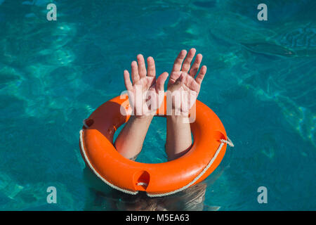 Close up of man hands through lifebelt in sea. Emergency drowning help concept Stock Photo