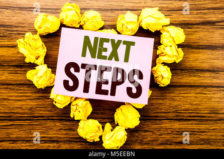 Word, writing Next Steps. Business concept for Future Golas and Target written on sticky note paper on wooden background. Stock Photo