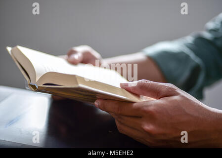 Closeup hand open book for reading concept background Stock Photo