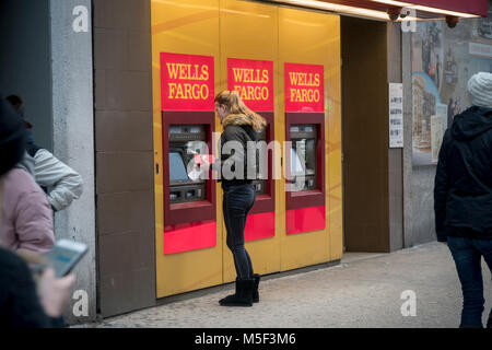 A woman uses a free standing Wells Fargo ATM  in New York on Saturday, February 17, 2018. Wells Fargo auditors, KPMG is expected to release a report on the bank's internal controls around March 1. (© Richard B. Levine) Stock Photo