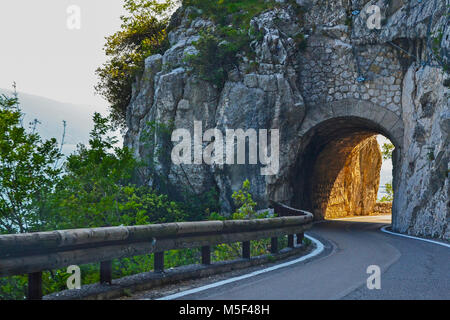 Narrow Italian road with a tunnel in the mountains, Strada Della Forra Stock Photo