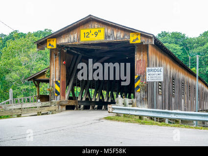 This is Harpersfield Covered Bridge that spans the Grand River in northeast Ohio the bridge is over a hundred years old and cars cross it every day. Stock Photo