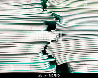 Pile of school notebooks on  shelf. Studio Photo Stock Photo