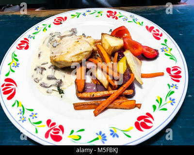 Chicken fillet, creamy sauce with mushrooms, stewed vegetables. Studio Photo