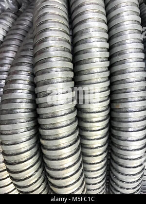 Background of gray corrugated metal tubes. Studio Photo Stock Photo