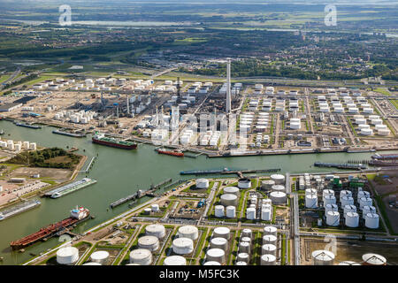 Aerial view of oil tankers moored at a oil storage terminal and oil refinery in a port. Stock Photo