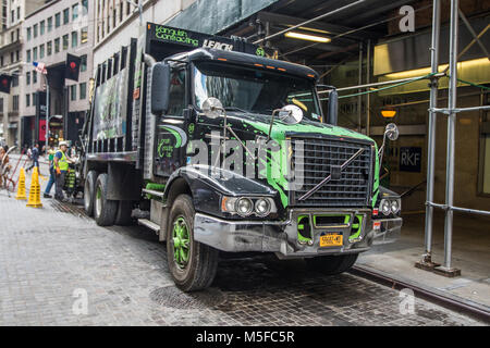 New York, August 17, 2016: Men are working on collecting garbage in their truck in downtown Manhattan. Stock Photo