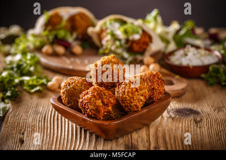 Fresh chickpeas falafel in wooden bowl Stock Photo