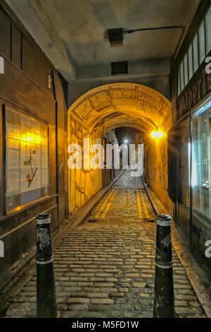 LONDON, UK-FEBRUARY 11, 2018: An old fashioned illuminated London Alleyway in the city. Stock Photo