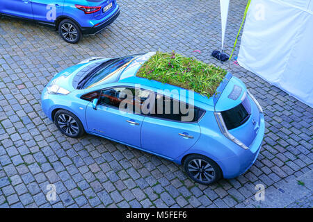 PRAGUE CZECH REPUBLIC - AUGUST 31, 2017;Small blue zero emission Nissan car with green roof and small solar panel parked on river embankment display.. Stock Photo