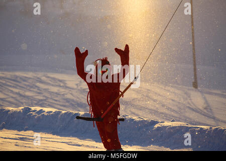Snowboarder in funny shrimp kigurumi pajamas costume at ski slope Stock Photo