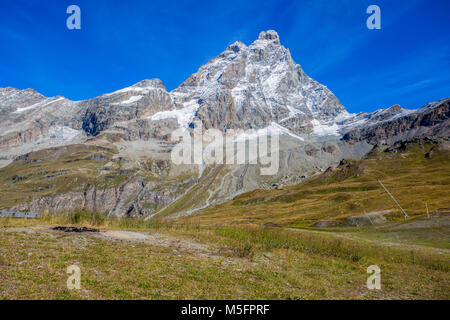 View of Cervino Mount (Matterhorn) from the cableway station of Plan Maison, above the mountain tourist town of Breuil-Cervinia at 2551 mt., in Val D' Stock Photo