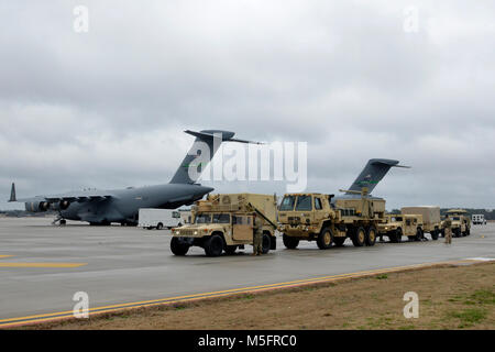 Paratroopers assigned to Headquarters and Headquarters Battalion, 82nd Airborne Division, offload vehicles and tactical systems from a C-17 Globemaster III aircraft on Pope Army Airfield at Fort Bragg, N.C., Feb. 10, 2018, during Operation Falcon Storm. OFS, a deployment readiness and joint forcible entry exercise, tested the Paratroopers ability to respond and fight within hours of notification. (U.S. Army photo by Staff Sgt. Elvis Umanzor) Stock Photo