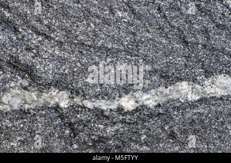 Quartz vein on granite-gneiss rock, nature texture of granite-gneiss rock a gneiss metamorphic rock that transformation from granite igneous rock and  Stock Photo