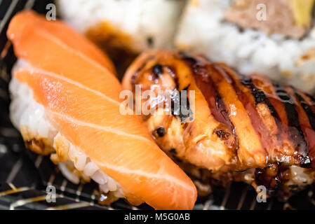 Mixed fresh fish sushi plate, macro food photography, selective focus. Japanese food, salmon, mackerel, tuna sushi, rice, pink, white, closeup. Stock Photo