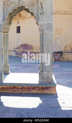 Ancient fortress, Amber fort, architectural detail, Jaipur, Rajasthan, India. Historic Amer fort, palace, tourist attraction, court and column, arch. Stock Photo