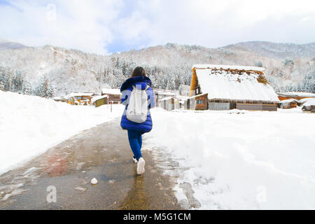 girl walking alone on the snow Stock Photo