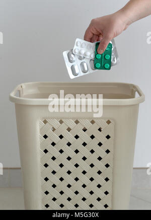 hand throwing pills away. Health concept Stock Photo