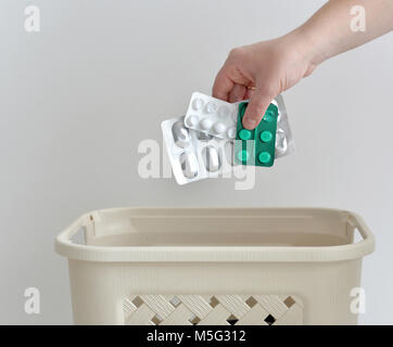 hand throwing pills away. Health concept Stock Photo