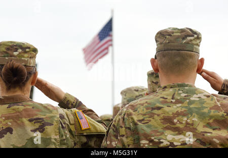 American Soldiers Saluting US Flag Stock Photo